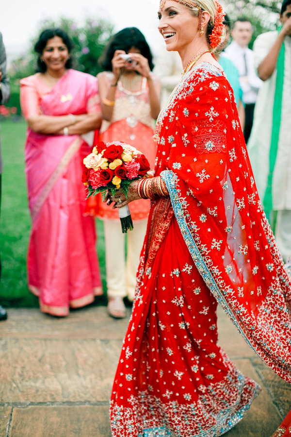smiling bride in beautiful red sari with aqua and gold accents - photo by Chicago based wedding photographers Harrison Studio
